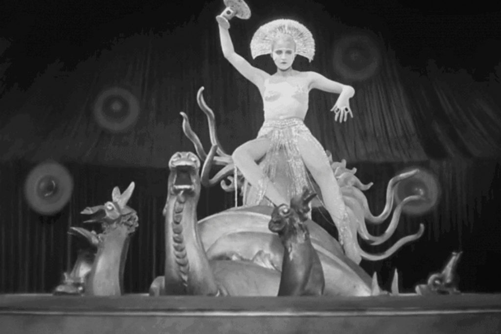 A Still from the Metropolis Movie, woman on some kind of mechanical snail
